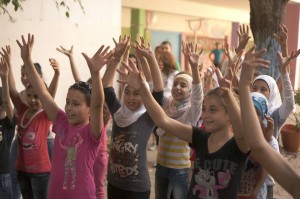 Syrian girls with their hands in the air