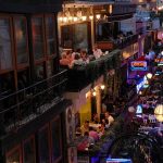 Street full of restaurant diners at night