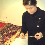 Woman making carpet