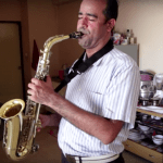 Man playing saxophone at home