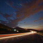 Deserted country road lit up at night