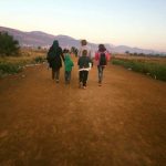 Family group walking on dust path