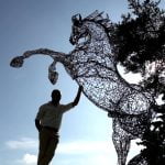 Mohannad next to a sculpture.